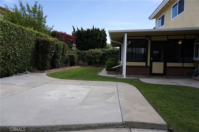18410 Alexander Ave, Cerritos, CA 90703 - view of green lawn with a sunroom and a patio
