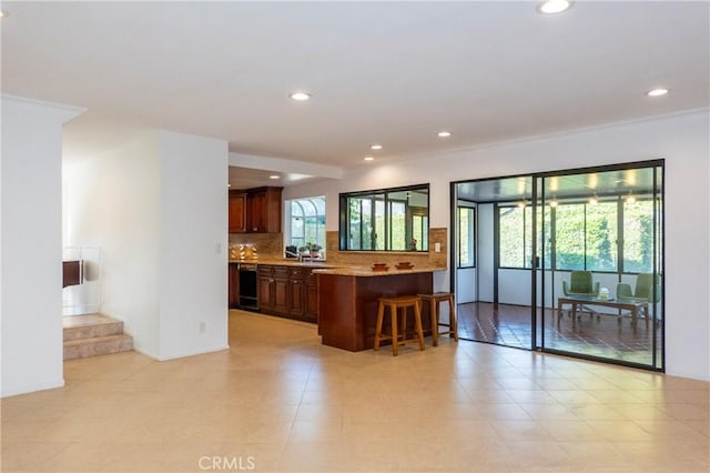 18410 Alexander Ave, Cerritos, CA 90703 - kitchen featuring a kitchen breakfast bar, recessed lighting, backsplash, light countertops, and a peninsula