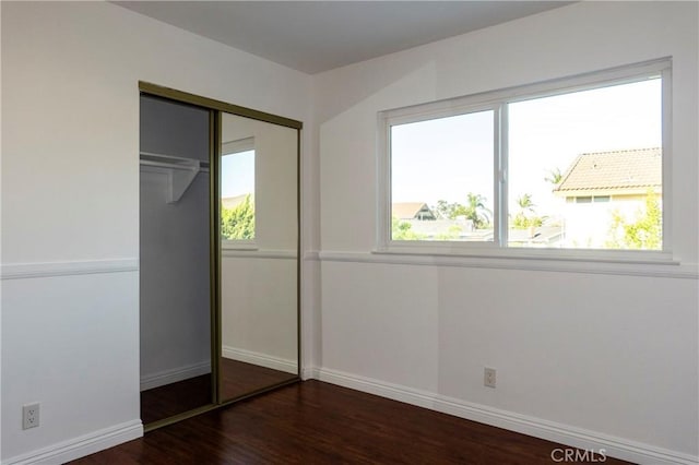18410 Alexander Ave, Cerritos, CA 90703 - unfurnished bedroom with multiple windows, wood finished floors, and a closet