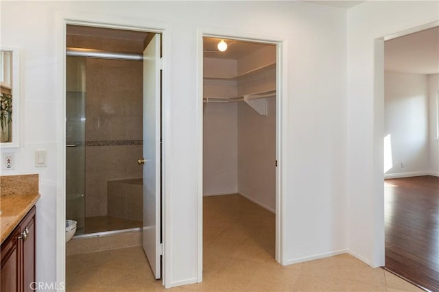 18410 Alexander Ave, Cerritos, CA 90703 - bathroom featuring vanity, a shower stall, and a walk in closet