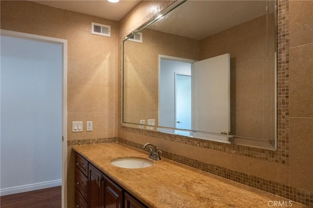 18410 Alexander Ave, Cerritos, CA 90703 - bathroom with vanity, tile walls, and decorative backsplash