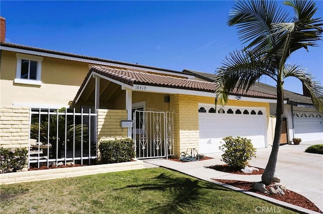 18410 Alexander Ave, Cerritos, CA 90703 - exterior space featuring driveway, a garage, stucco siding, a tiled roof, and brick siding