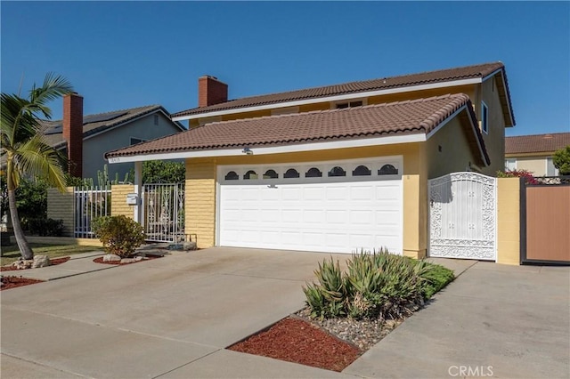 18410 Alexander Ave, Cerritos, CA 90703 - view of front of property featuring a gate, concrete driveway, an attached garage, a tiled roof, and stucco siding
