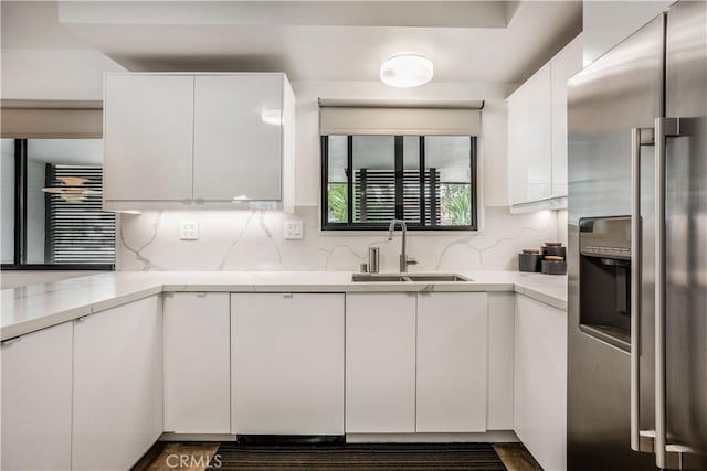 22335 Tiara St, Woodland Hills, CA 91367 - kitchen featuring white cabinetry, a sink, and stainless steel fridge