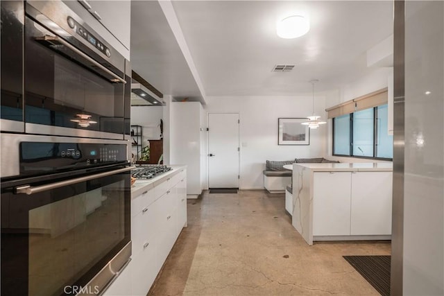 22335 Tiara St, Woodland Hills, CA 91367 - kitchen with white cabinets, stainless steel appliances, visible vents, and light countertops