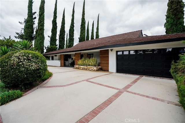22335 Tiara St, Woodland Hills, CA 91367 - ranch-style home with a garage, driveway, and stucco siding