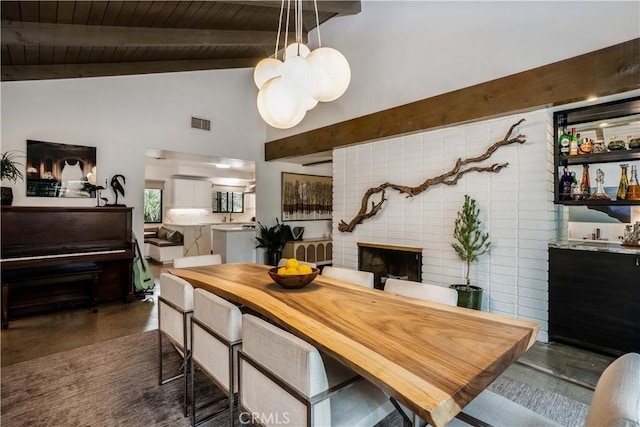 22335 Tiara St, Woodland Hills, CA 91367 - dining room with visible vents, beam ceiling, wood ceiling, a brick fireplace, and high vaulted ceiling