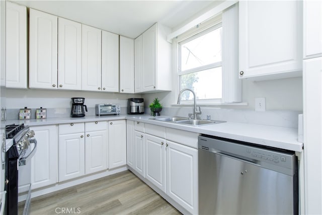 kitchen featuring a sink, light countertops, white cabinetry, and stainless steel appliances