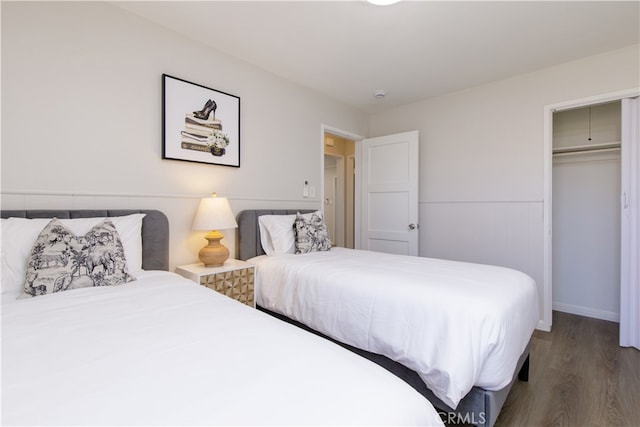 bedroom with a closet, baseboards, and wood finished floors
