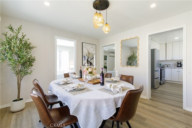 dining area with baseboards, recessed lighting, and light wood-style floors