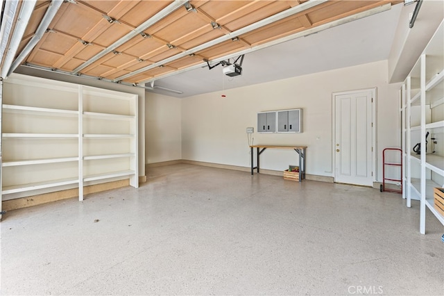 garage featuring baseboards and a garage door opener