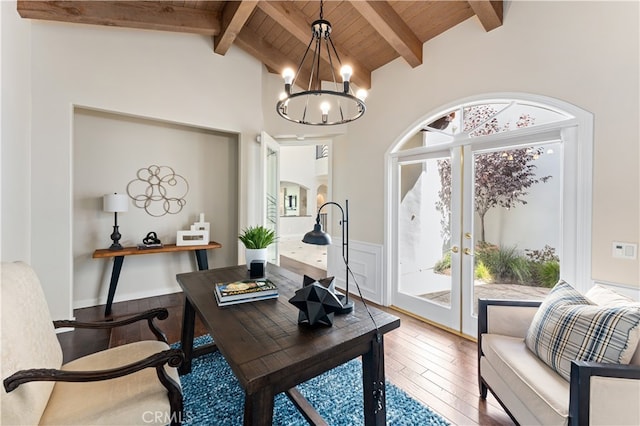 office space featuring a chandelier, wood ceiling, french doors, vaulted ceiling with beams, and hardwood / wood-style floors