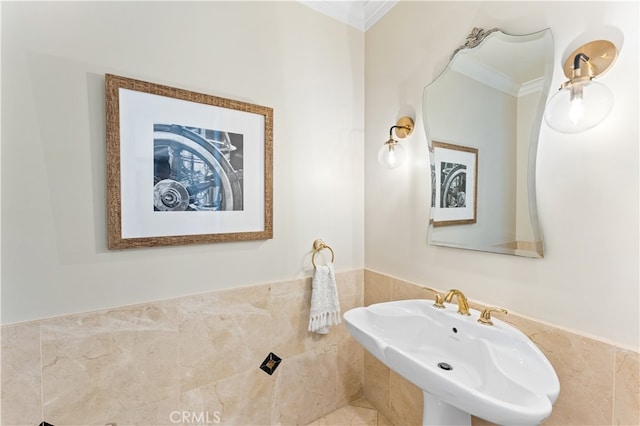bathroom with crown molding and a sink
