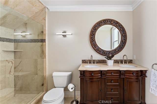 full bath with a sink, toilet, a shower stall, and crown molding