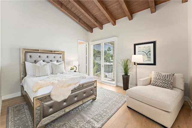 bedroom with access to outside, baseboards, lofted ceiling with beams, wooden ceiling, and wood finished floors