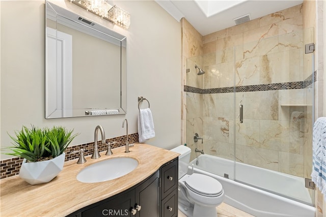 bathroom with tasteful backsplash, visible vents, combined bath / shower with glass door, toilet, and vanity