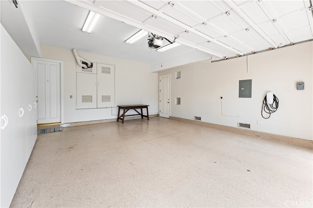garage featuring electric panel and a garage door opener