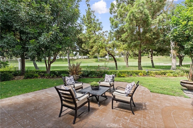 view of patio featuring an outdoor living space and fence