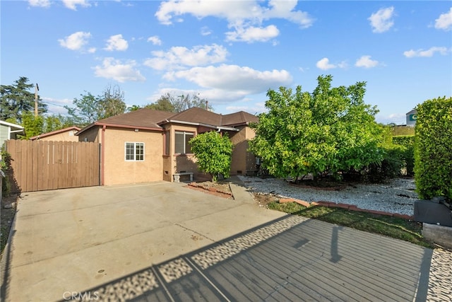 view of front of home with stucco siding and fence