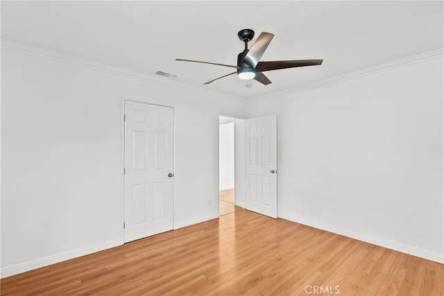 unfurnished bedroom with visible vents, ornamental molding, and light wood-style flooring
