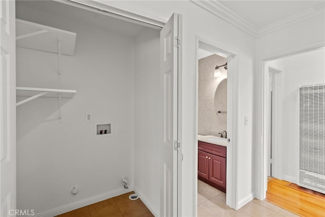 laundry room featuring hookup for a gas dryer, light tile patterned floors, crown molding, washer hookup, and a heating unit