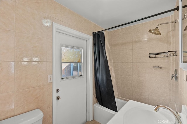 bathroom with shower / bath combo, tile walls, a sink, and toilet