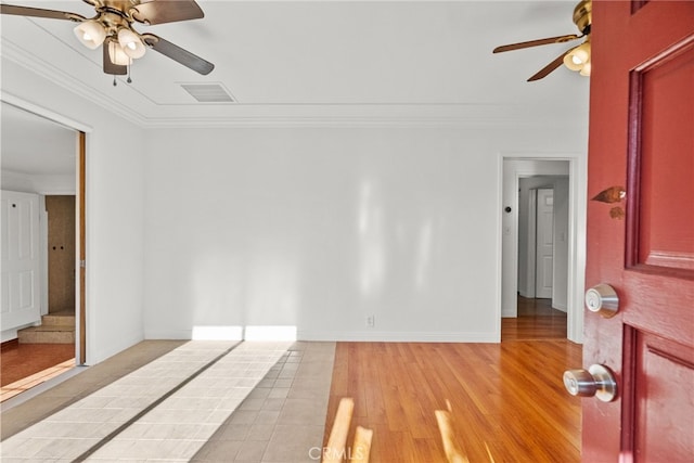 unfurnished bedroom with visible vents, baseboards, crown molding, and a ceiling fan
