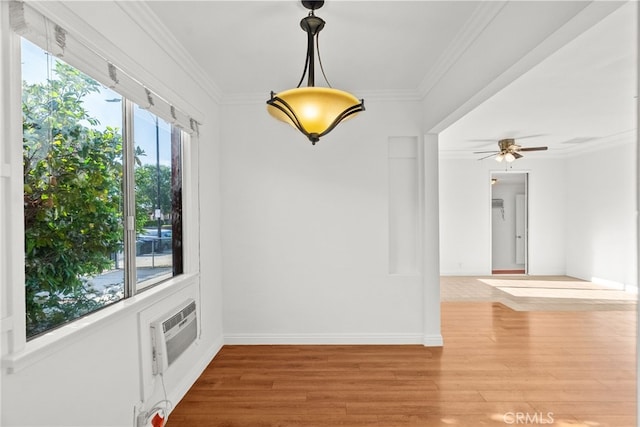 unfurnished room with a wall mounted AC, baseboards, a ceiling fan, and wood finished floors