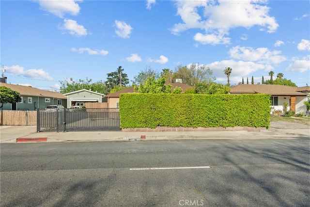 view of front of property featuring a fenced front yard and a gate