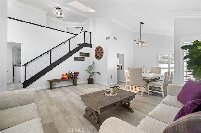 1212 Goldenview Dr, Corona, CA 92882 - living room featuring stairs, a skylight, ornamental molding, a towering ceiling, and wood finished floors