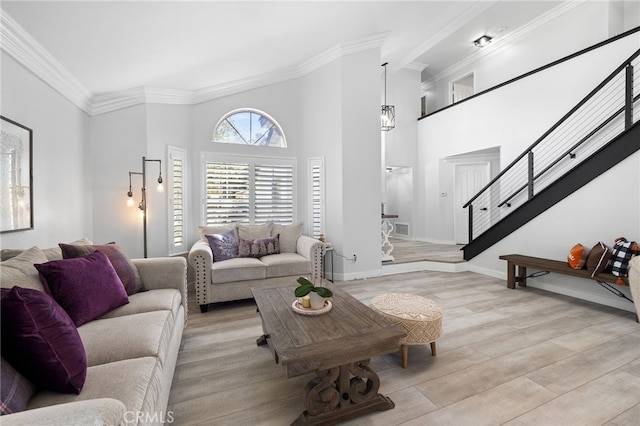 1212 Goldenview Dr, Corona, CA 92882 - living area with stairway, ornamental molding, light wood-style floors, a high ceiling, and baseboards