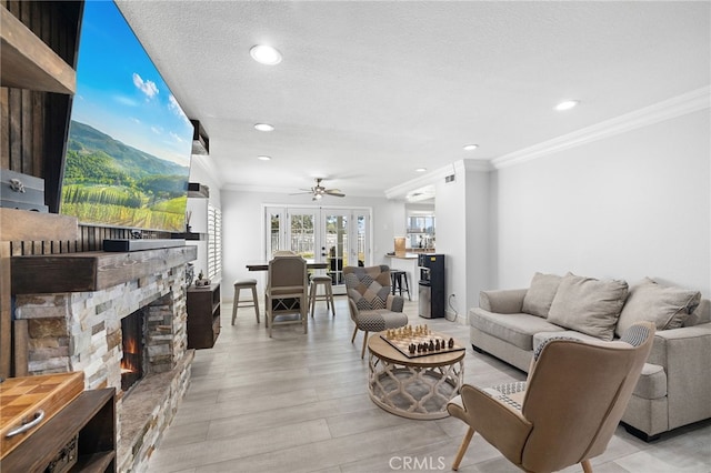1212 Goldenview Dr, Corona, CA 92882 - living room with crown molding, a stone fireplace, light wood-style flooring, recessed lighting, and ceiling fan