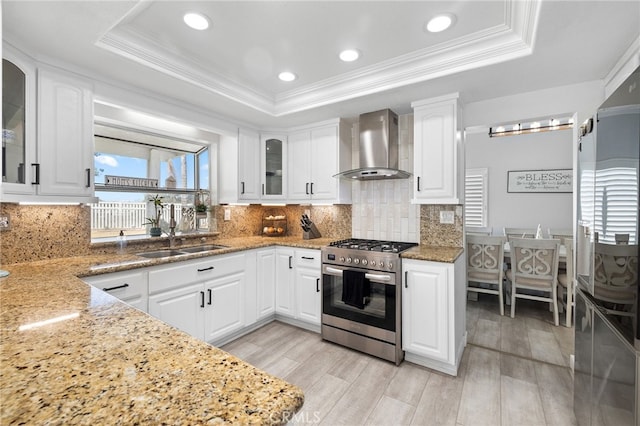 1212 Goldenview Dr, Corona, CA 92882 - kitchen with wall chimney range hood, gas stove, a sink, a raised ceiling, and light stone counters