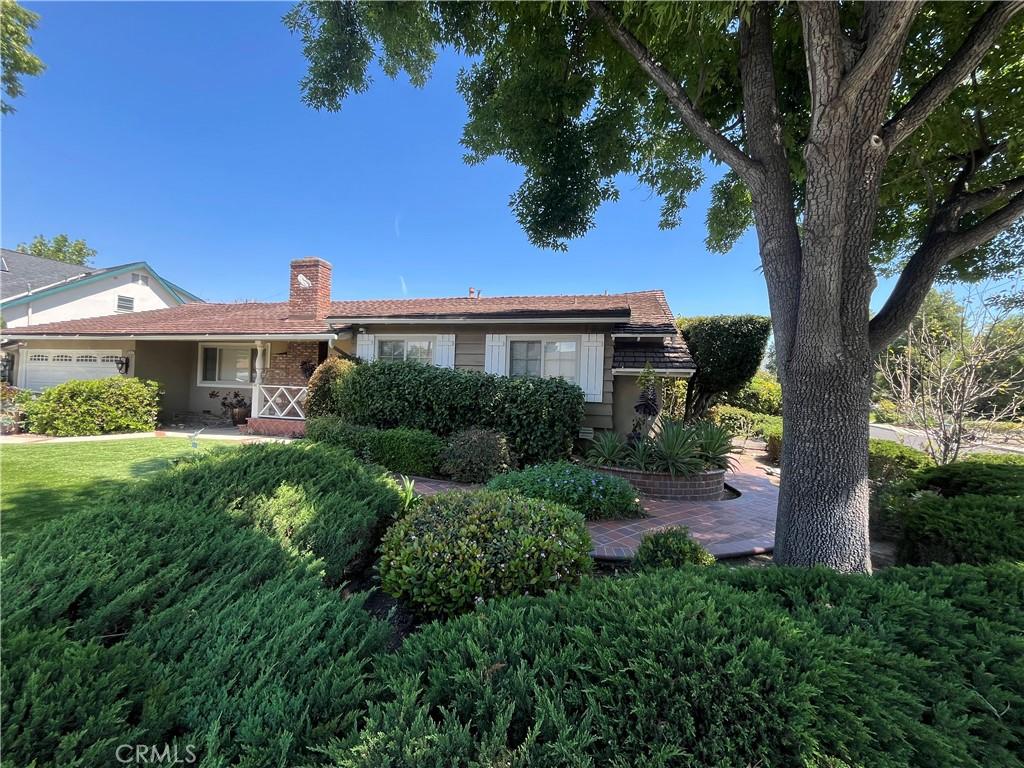 1006 Vanderbilt Ave, Claremont, CA 91711 - view of front of house featuring an attached garage, a chimney, and a porch