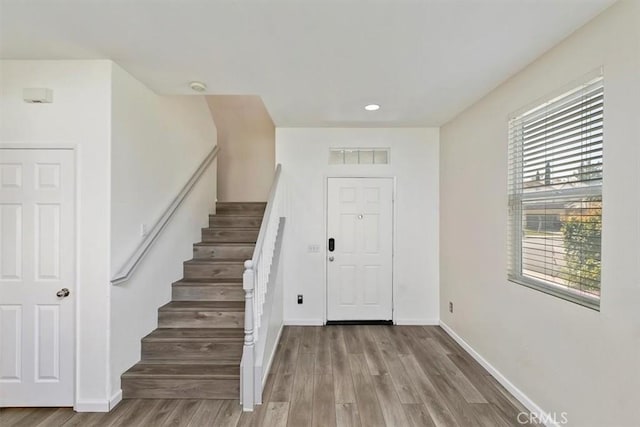 foyer featuring visible vents, recessed lighting, stairway, wood finished floors, and baseboards