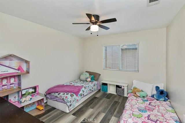 bedroom with visible vents, ceiling fan, and wood finished floors