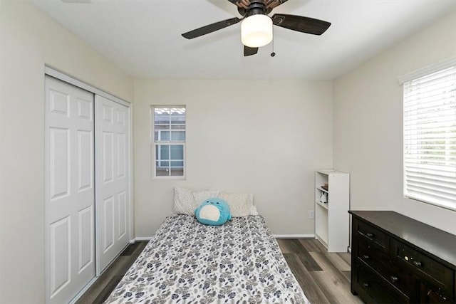 bedroom with dark wood-type flooring, a closet, and ceiling fan