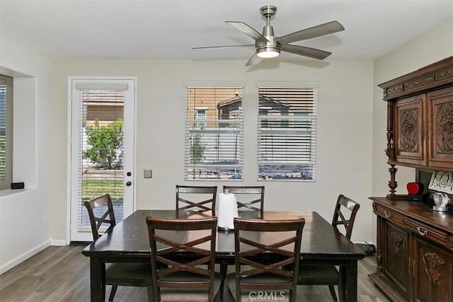 dining room with baseboards, wood finished floors, and ceiling fan
