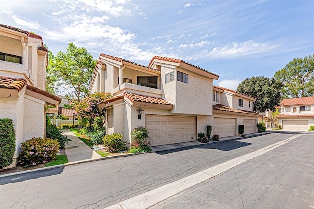 22933 Estoril Dr Unit 1, Diamond Bar, CA 91765 - view of front of house featuring a garage, stucco siding, a residential view, and a tile roof