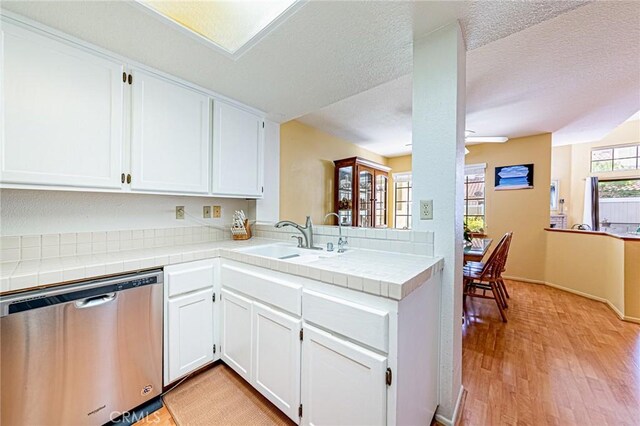 22933 Estoril Dr Unit 1, Diamond Bar, CA 91765 - kitchen featuring white cabinets, dishwasher, a sink, light wood finished floors, and tile counters
