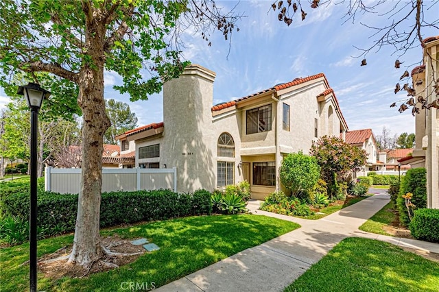 22933 Estoril Dr Unit 1, Diamond Bar, CA 91765 - mediterranean / spanish-style home with a tile roof, fence, a front lawn, and stucco siding