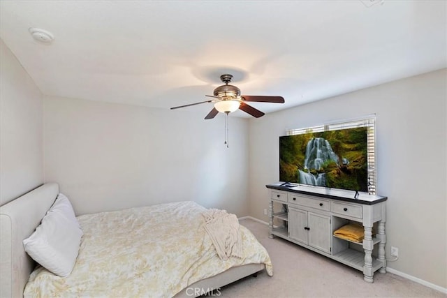 bedroom featuring light carpet, baseboards, and a ceiling fan