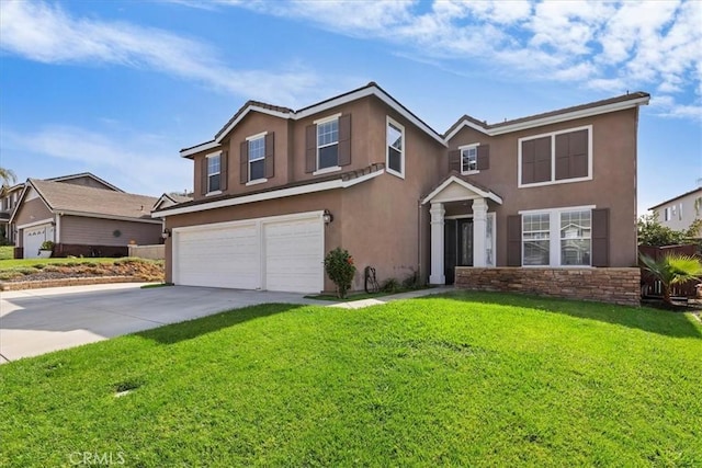 traditional home with a garage, a front yard, driveway, and stucco siding