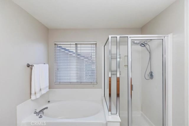 bathroom featuring a garden tub and a stall shower