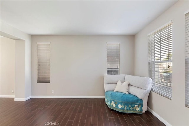 sitting room featuring baseboards and wood finished floors