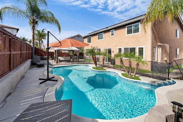 view of swimming pool with a fenced in pool, a patio area, and a fenced backyard