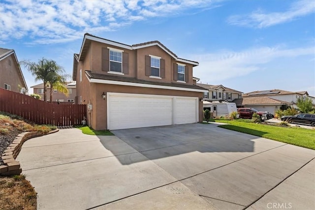 traditional-style house featuring concrete driveway, a residential view, stucco siding, a garage, and fence