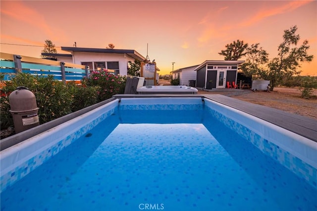 outdoor pool with an outdoor structure and fence