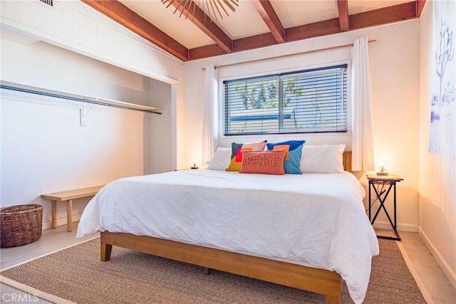 carpeted bedroom with lofted ceiling with beams and baseboards