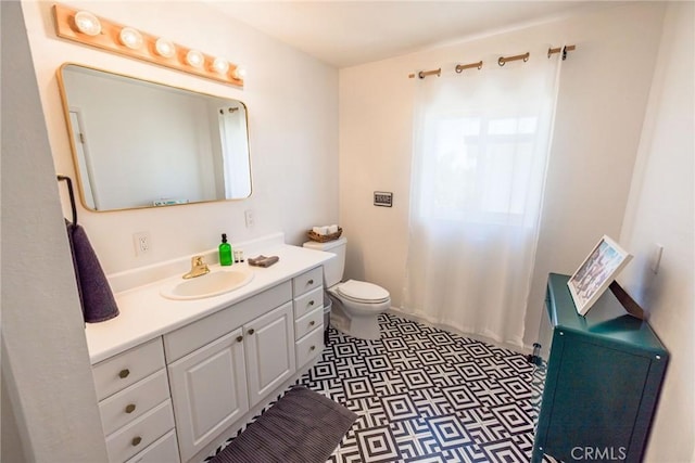 bathroom featuring toilet, tile patterned floors, and vanity